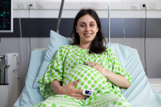 portrait smiling patient with pregnancy waiting receive medical examination from doctor check healthcare woman expecting child preparing give birth hospital ward scaled e1754380254625